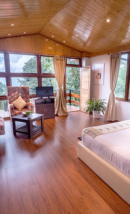 Deluxe room with mountain-view windows at Kaya Gantavya Resort & Spa, Pelling